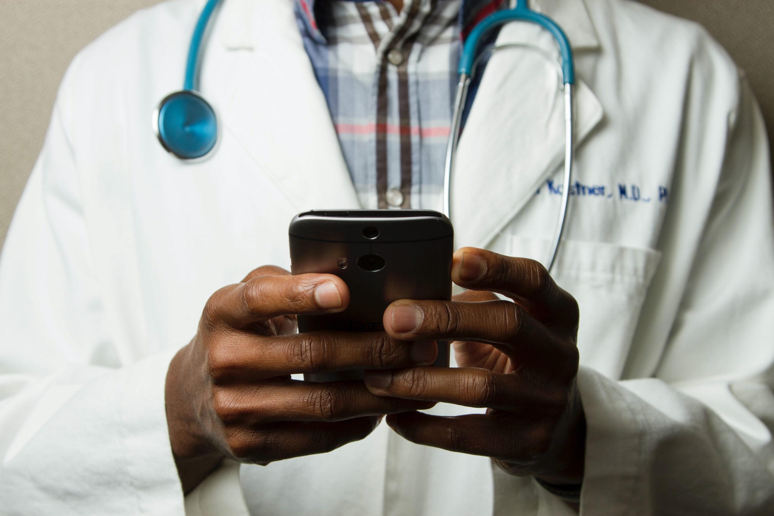 physician takes virtual appointment from phone