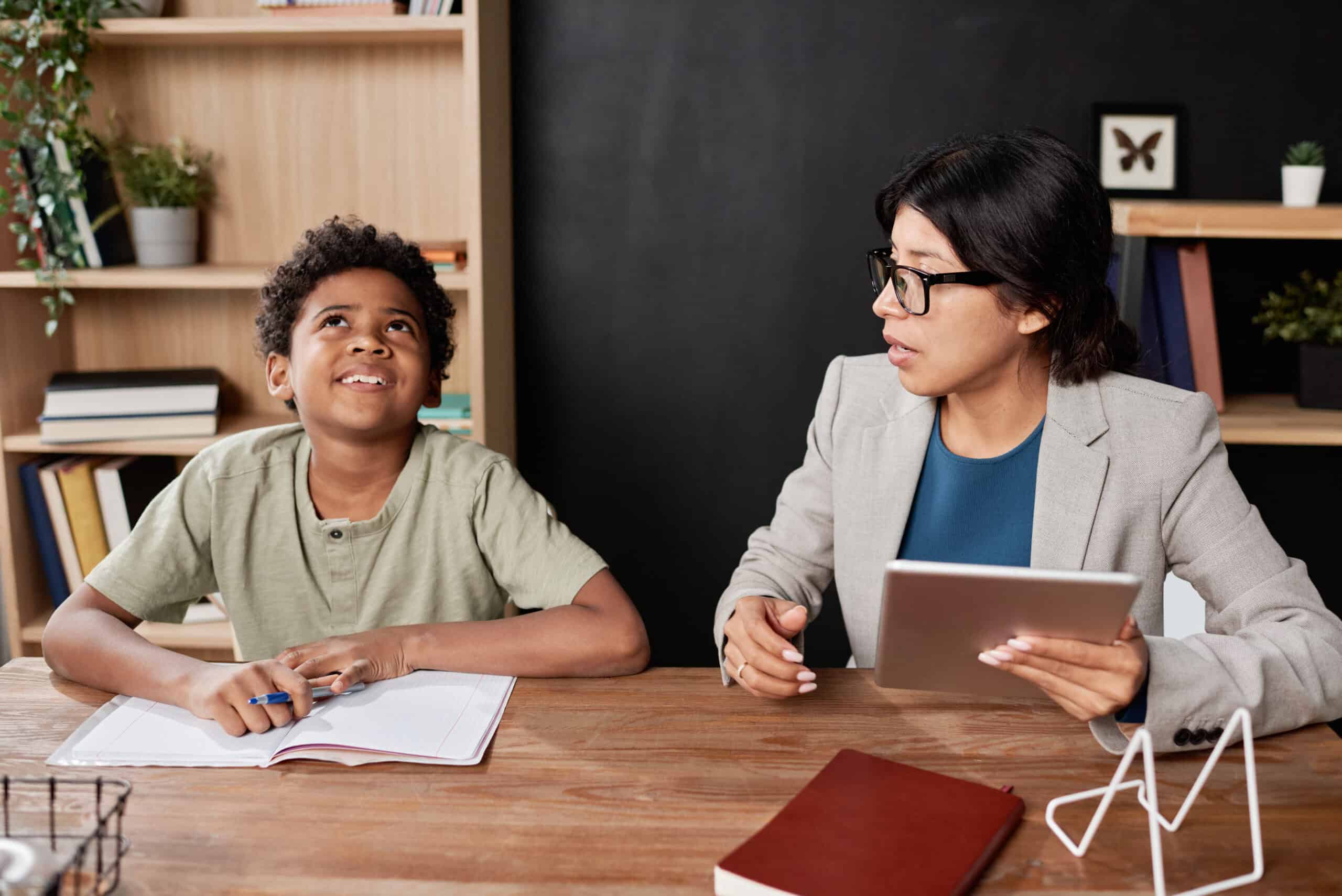 Hispanic tutor working with naughty student